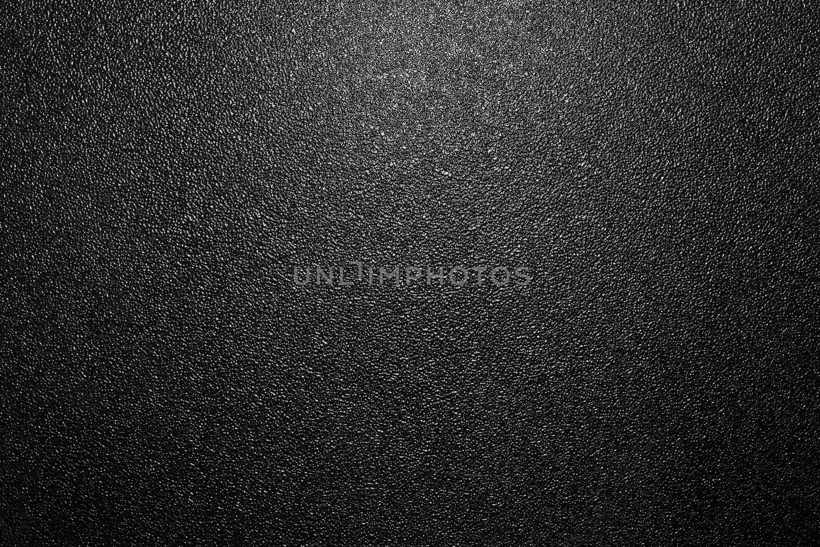 Dark full frame background of hammered powder paint coating on flat sheet steel surface. Also known as hammertone effect.