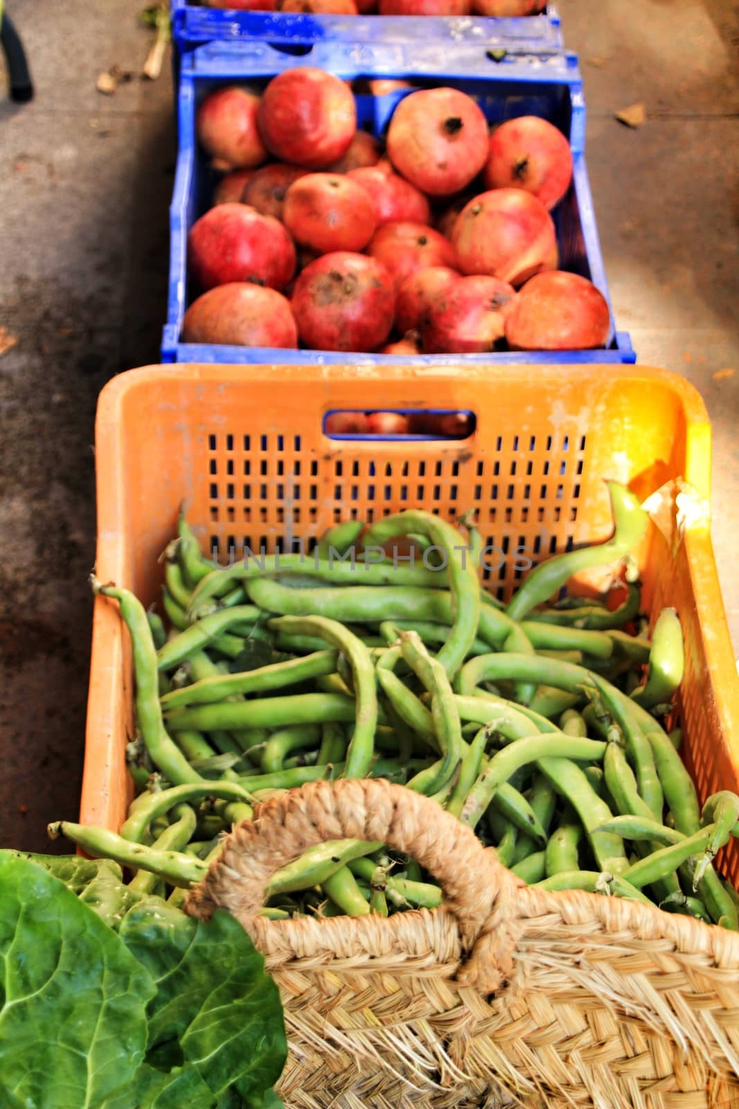Green vegetables and grenades for sale at a ecological market stall by soniabonet