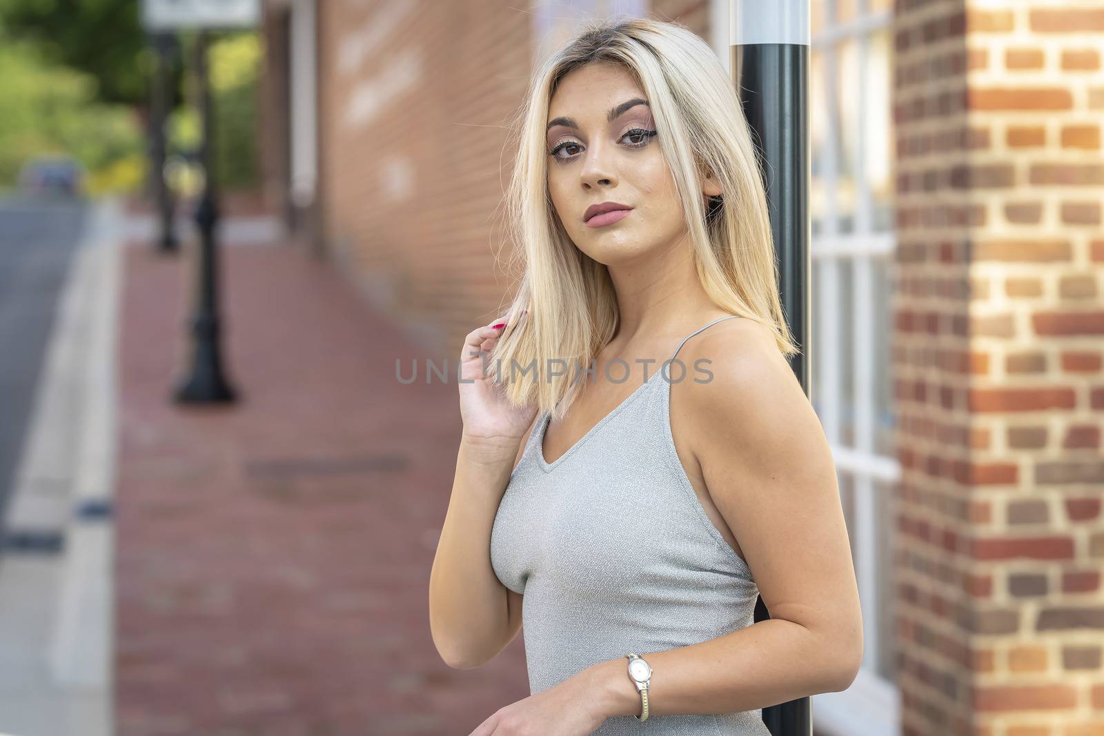 A Young Lovely Blonde Model Poses Outdoors While Enjoying A Summers Day by actionsports