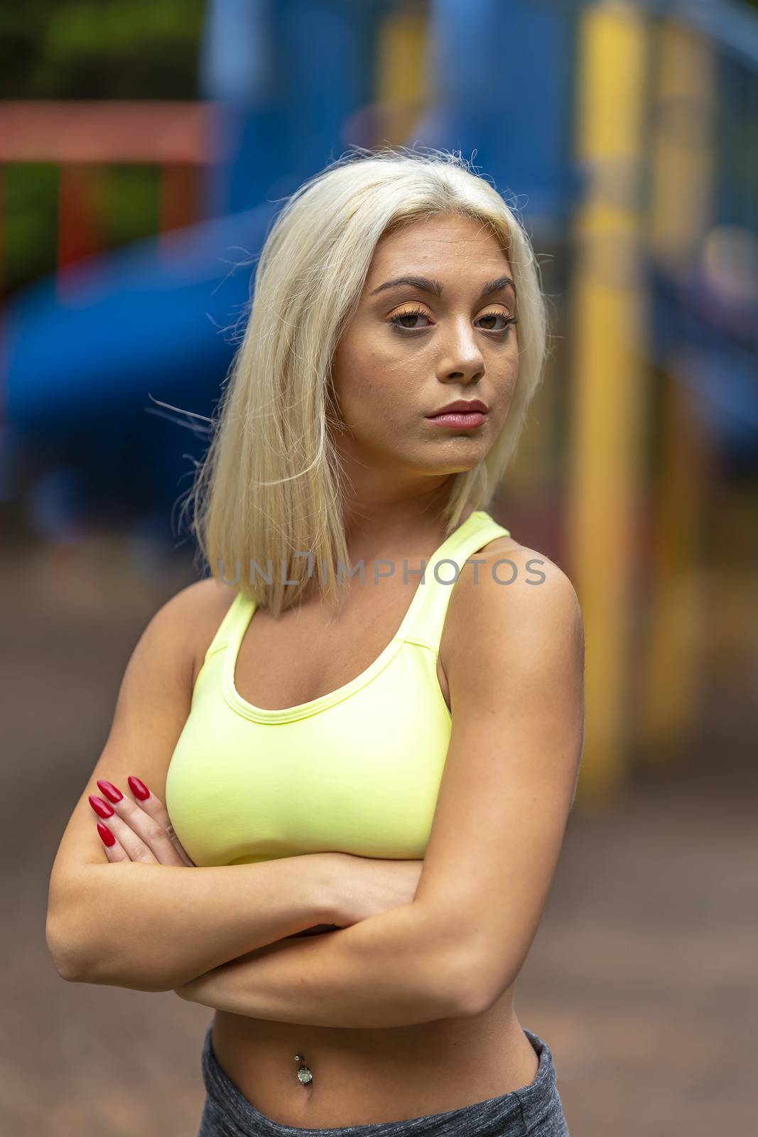 A gorgeous young blonde model works out outdoors while enjoying a summers day