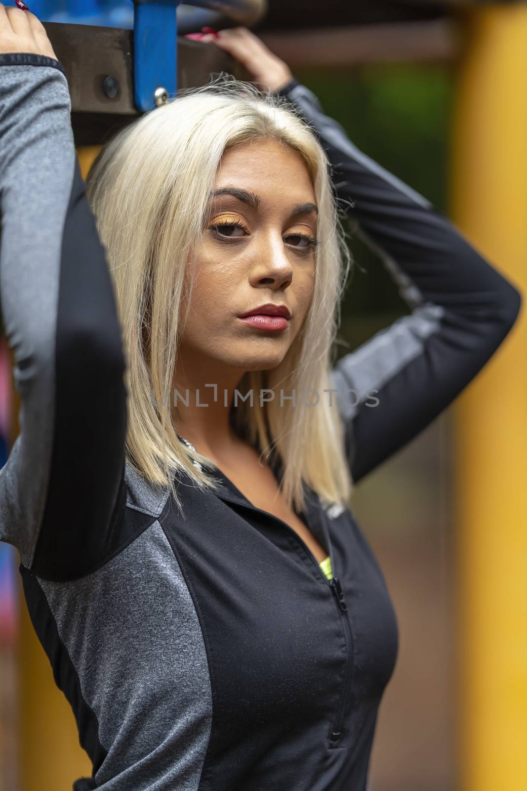 A Young Lovely Blonde Model Works Out Outdoors While Enjoying A Summers Day by actionsports