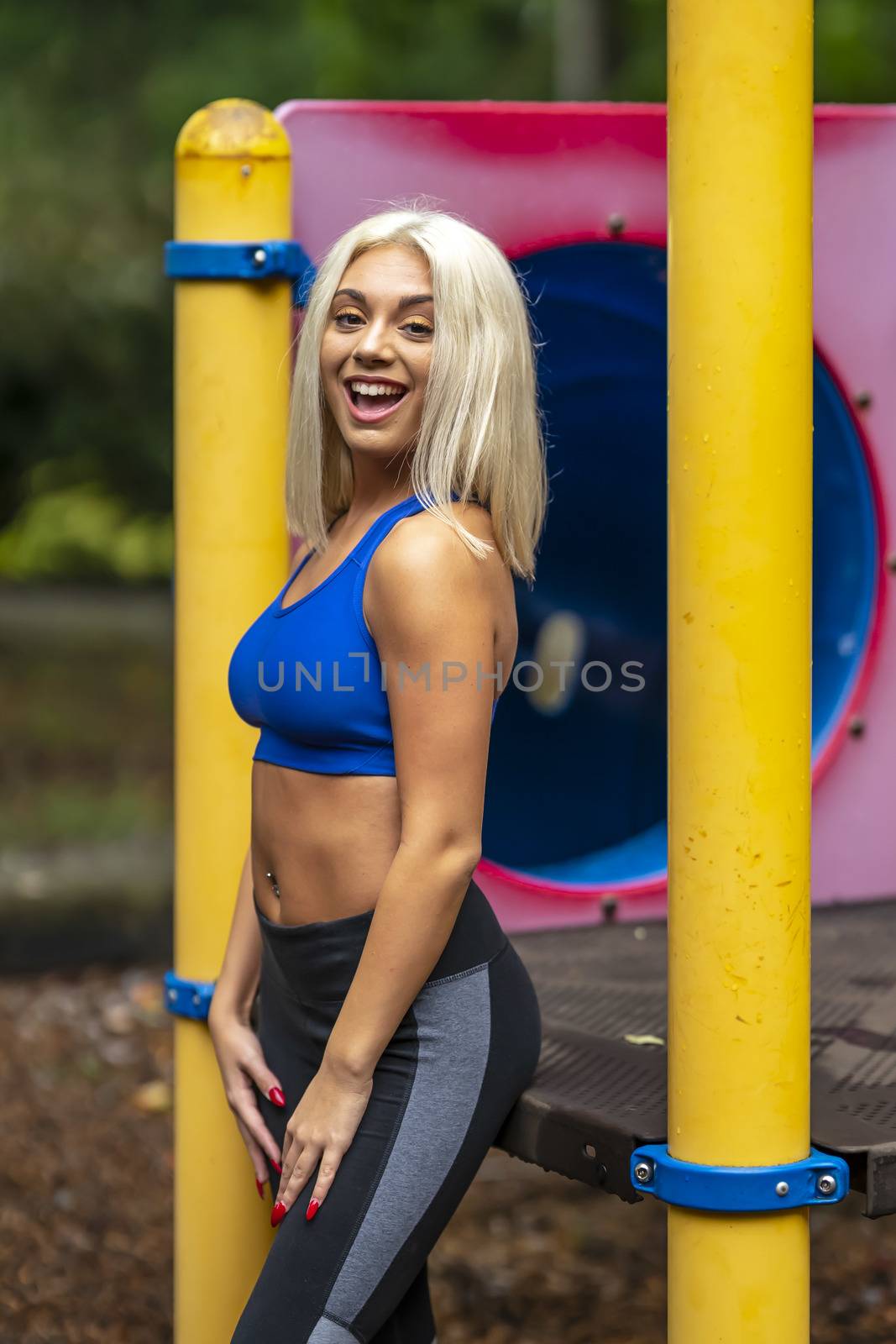 A Young Lovely Blonde Model Works Out Outdoors While Enjoying A Summers Day by actionsports