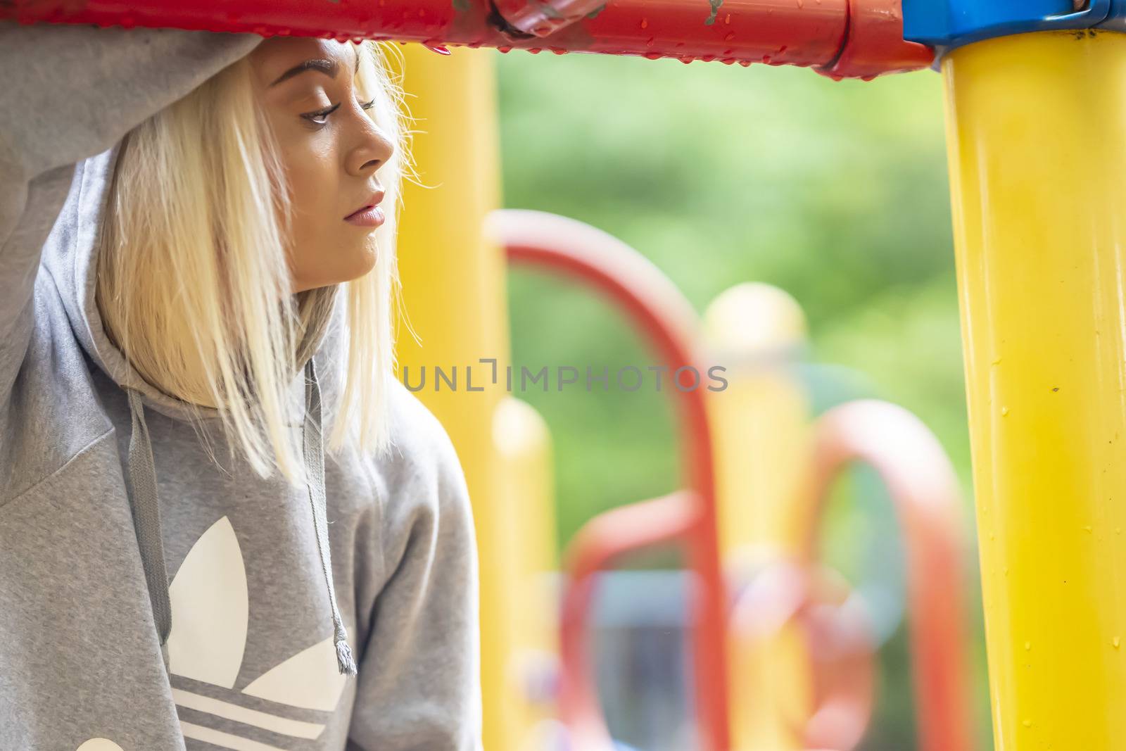 A gorgeous young blonde model works out outdoors while enjoying a summers day