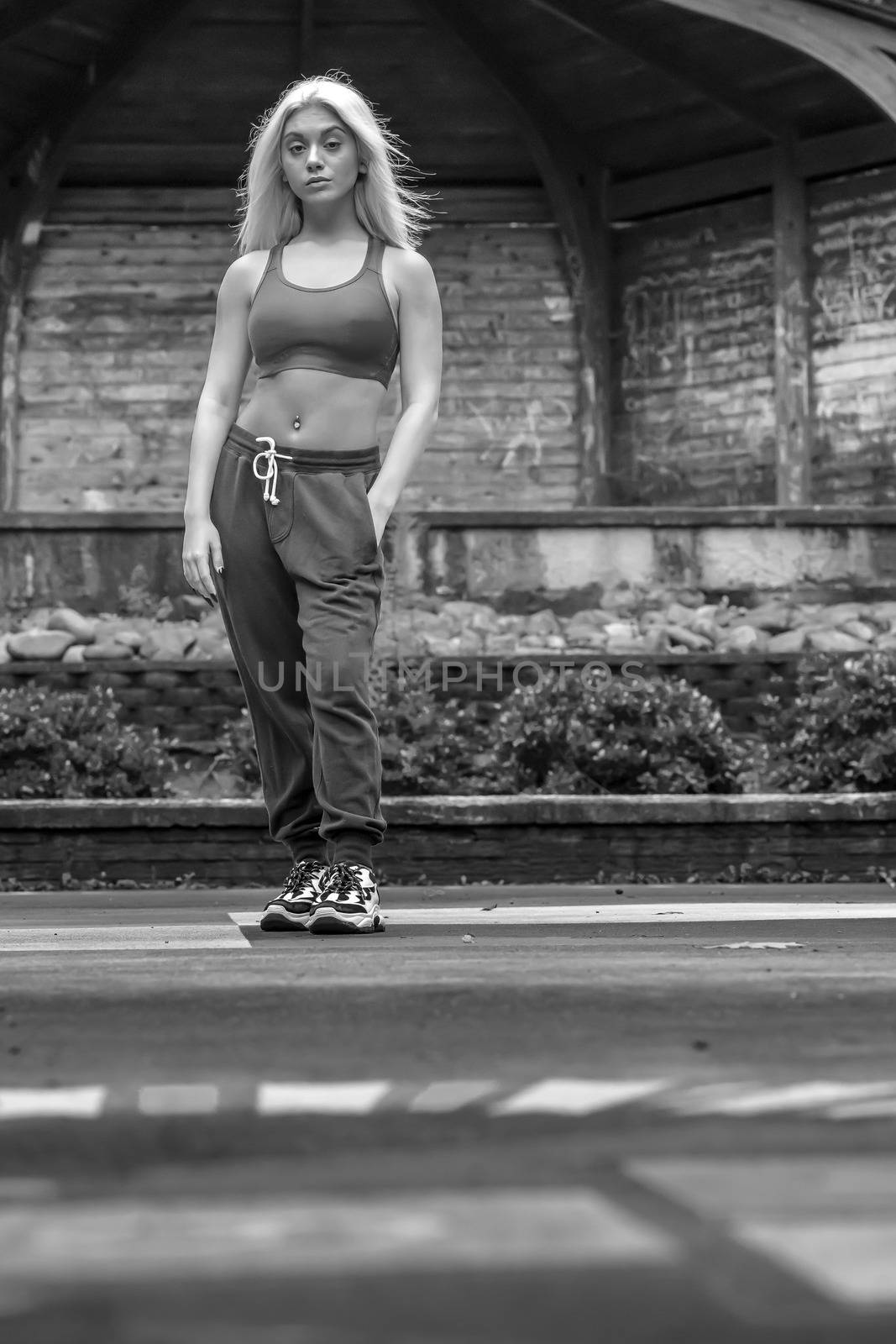 A Young Lovely Blonde Model Works Out Outdoors While Enjoying A Summers Day by actionsports