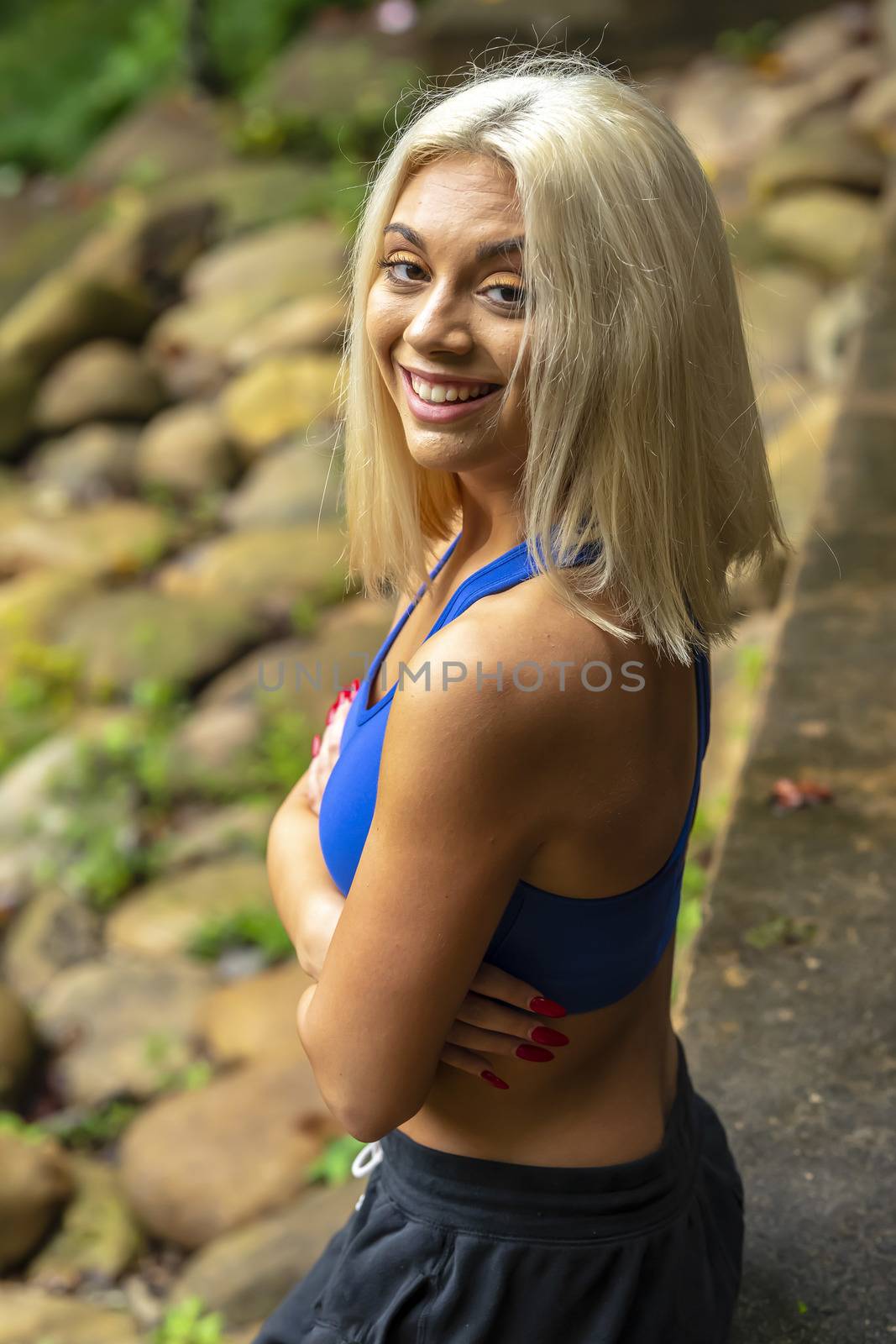 A Young Lovely Blonde Model Works Out Outdoors While Enjoying A Summers Day by actionsports