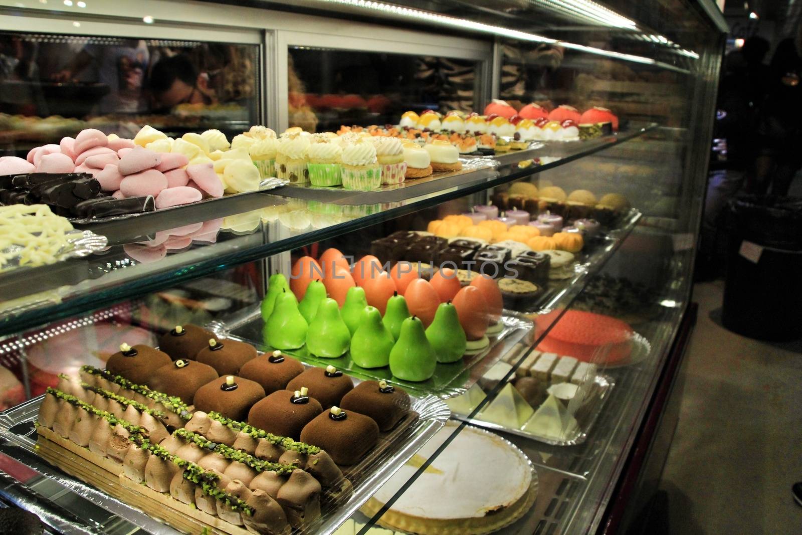 Tray of cakes and sweets in a pastry shop by soniabonet