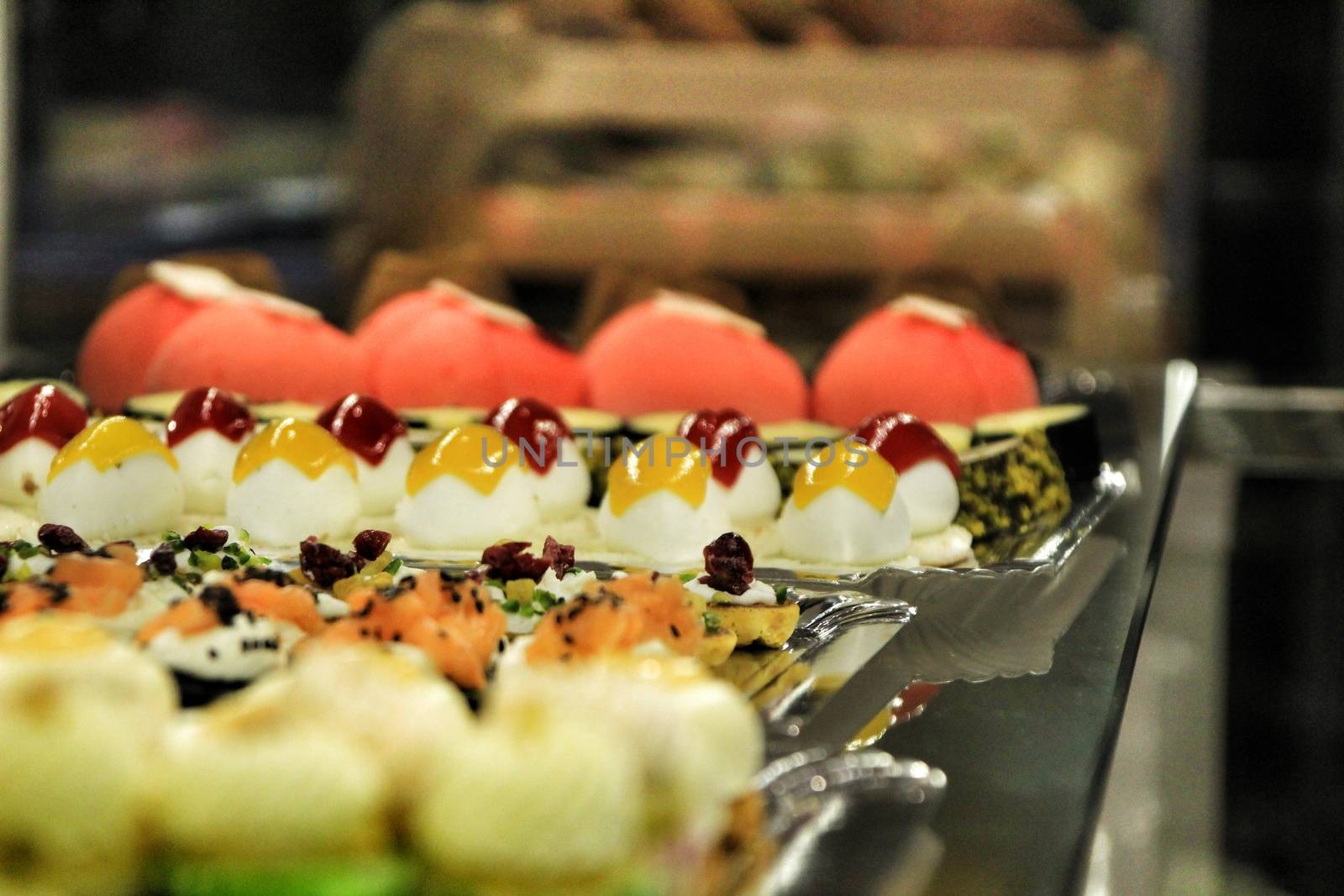 Tray of cakes and sweets in a pastry shop by soniabonet