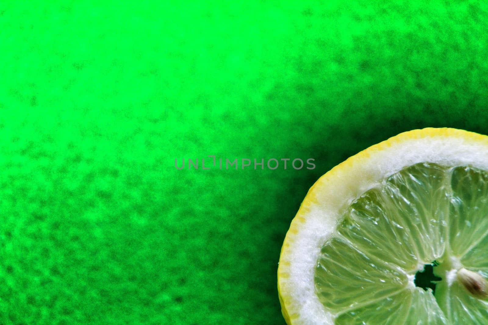 Slice of lemon on colorful green background