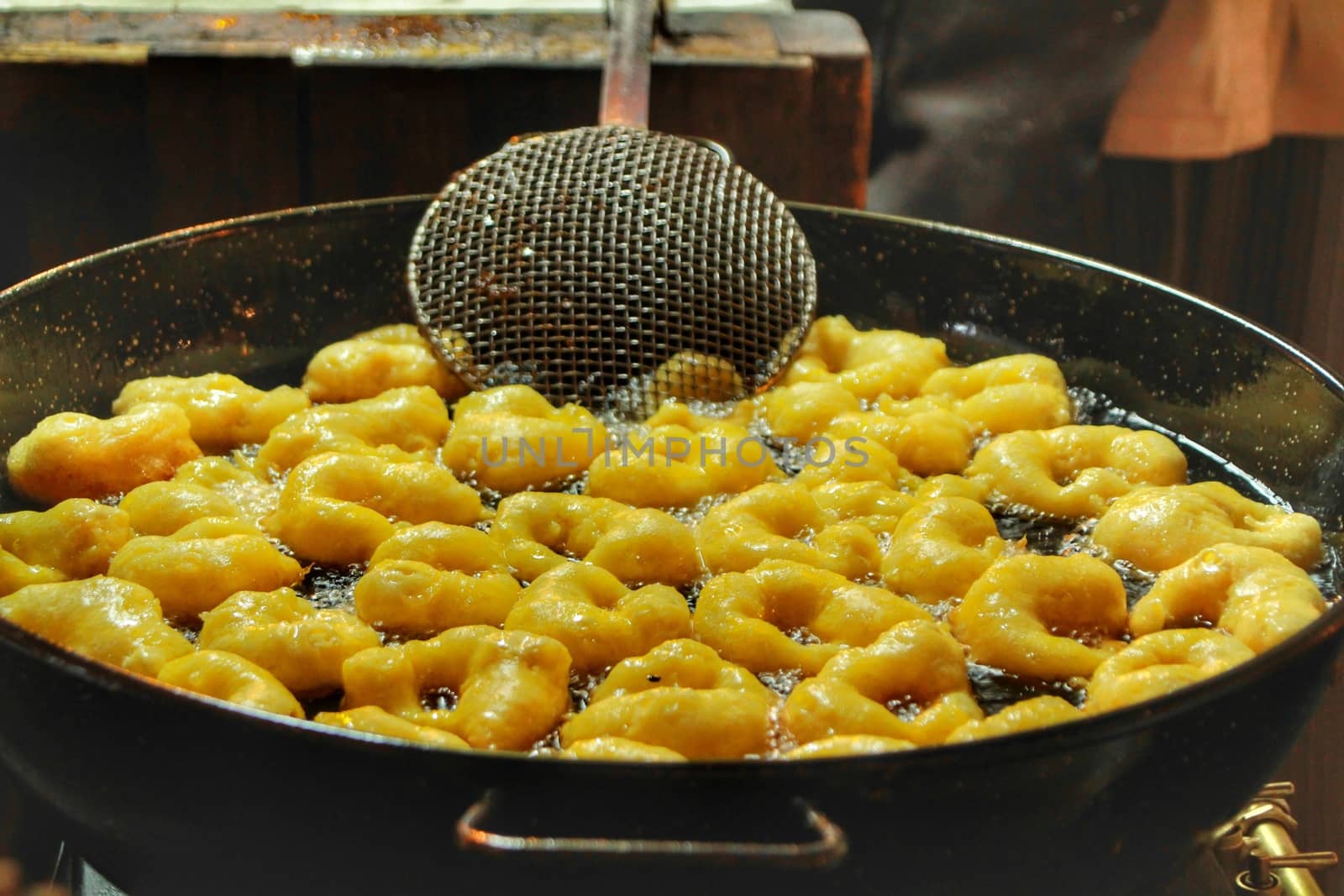 Pumpkin fritters in boiling oil at a street stall by soniabonet