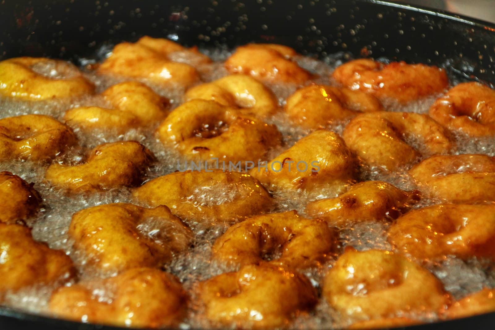 Pumpkin fritters in boiling oil at a street stall by soniabonet