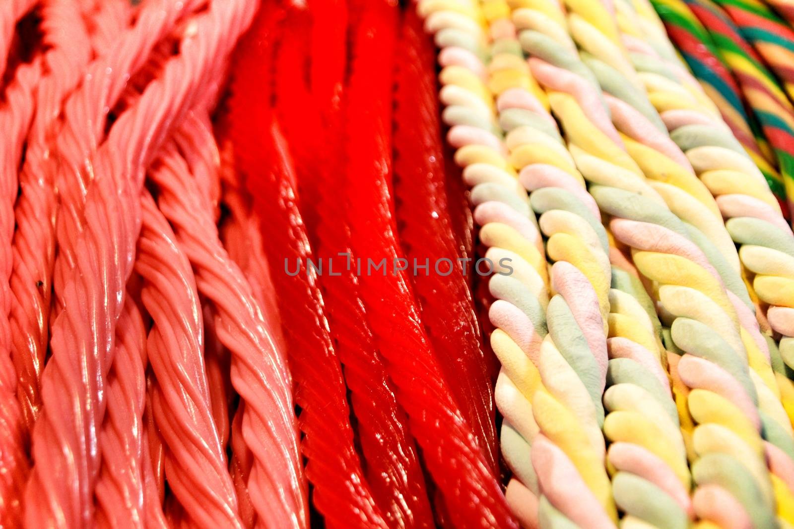 Candies of various colors and flavors in a street stall by soniabonet