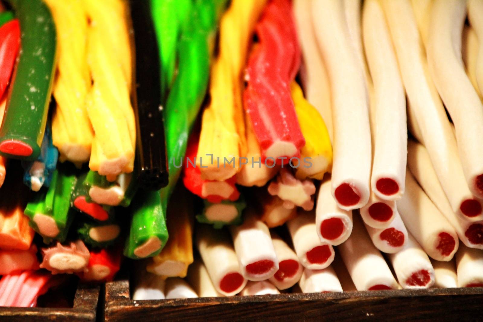 Candies of various colors and flavors in a street stall by soniabonet