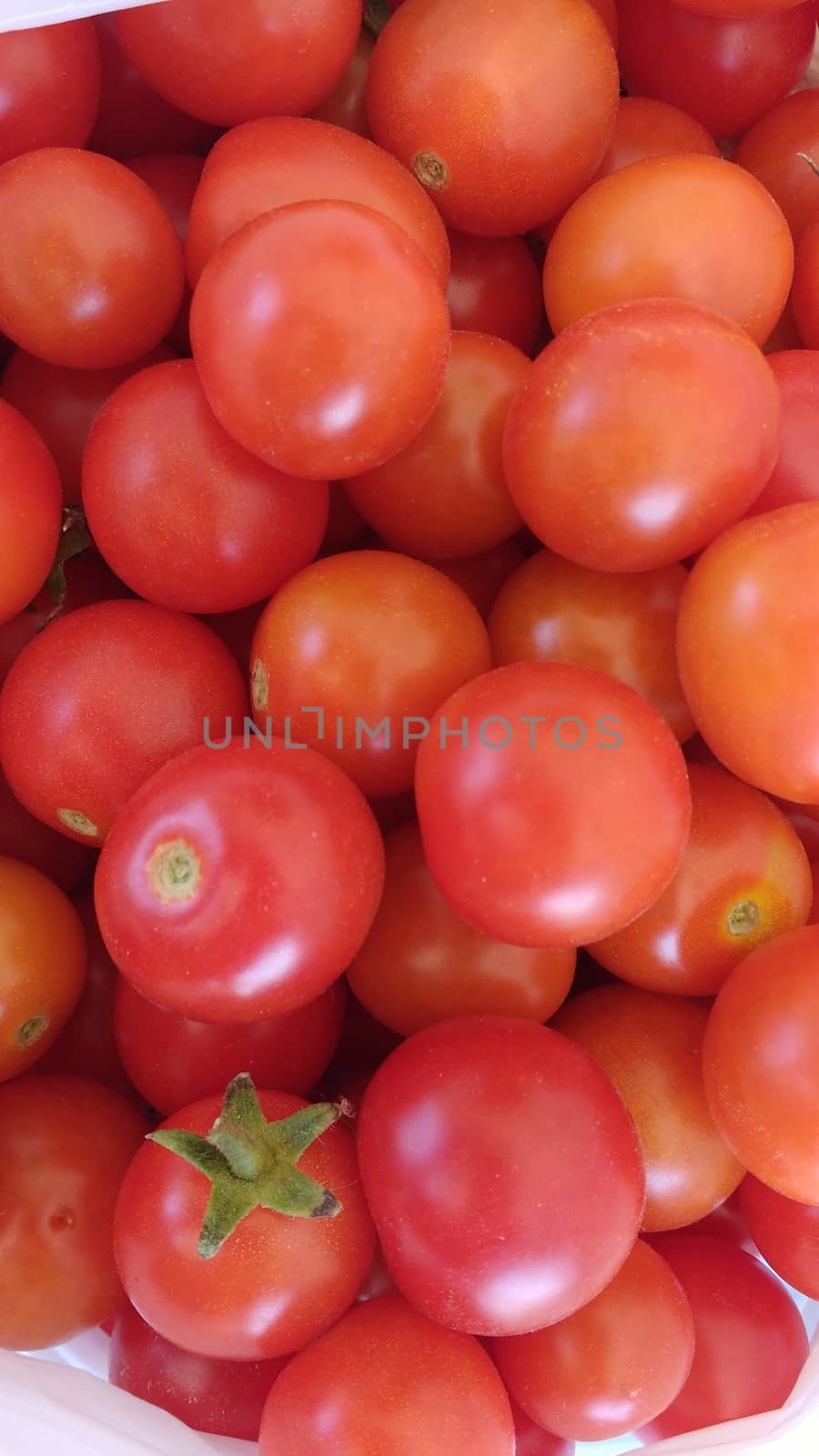 Little red tomatoes background and texture