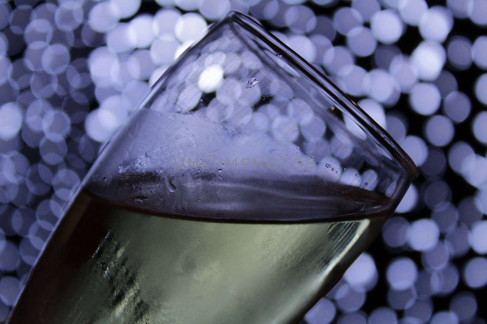 Champagne glass over Christmas light bokeh by soniabonet