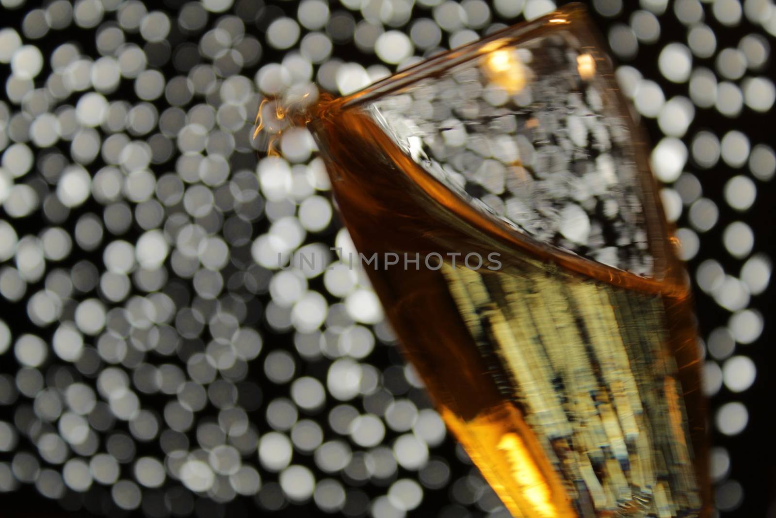 Champagne glasses toasting over Christmas light fantasy bokeh