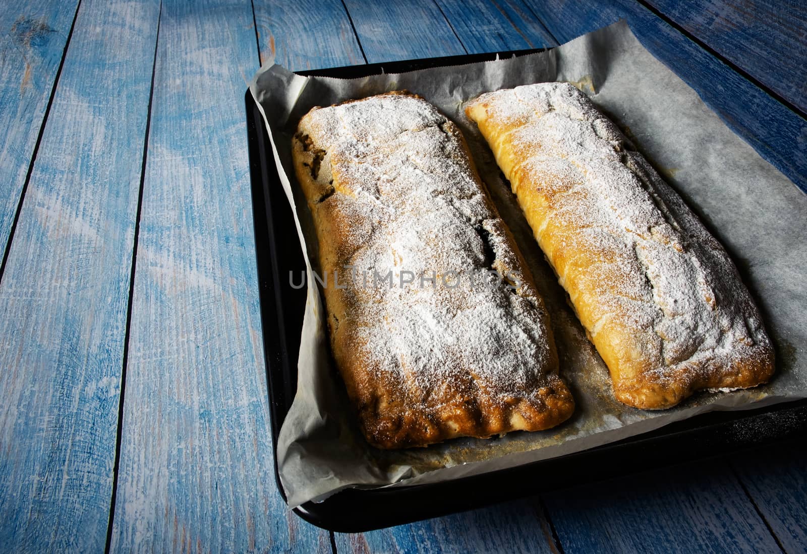 food background bakery with strudel on blue plates