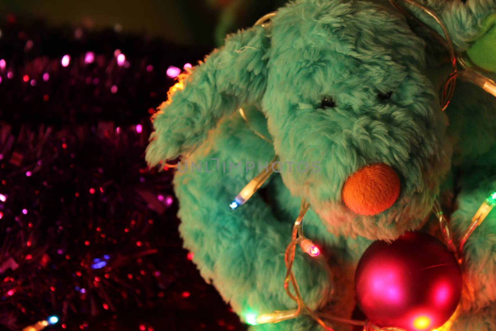 Teddy bear with Christmas tree balls, garlands and other colorful decorative elements