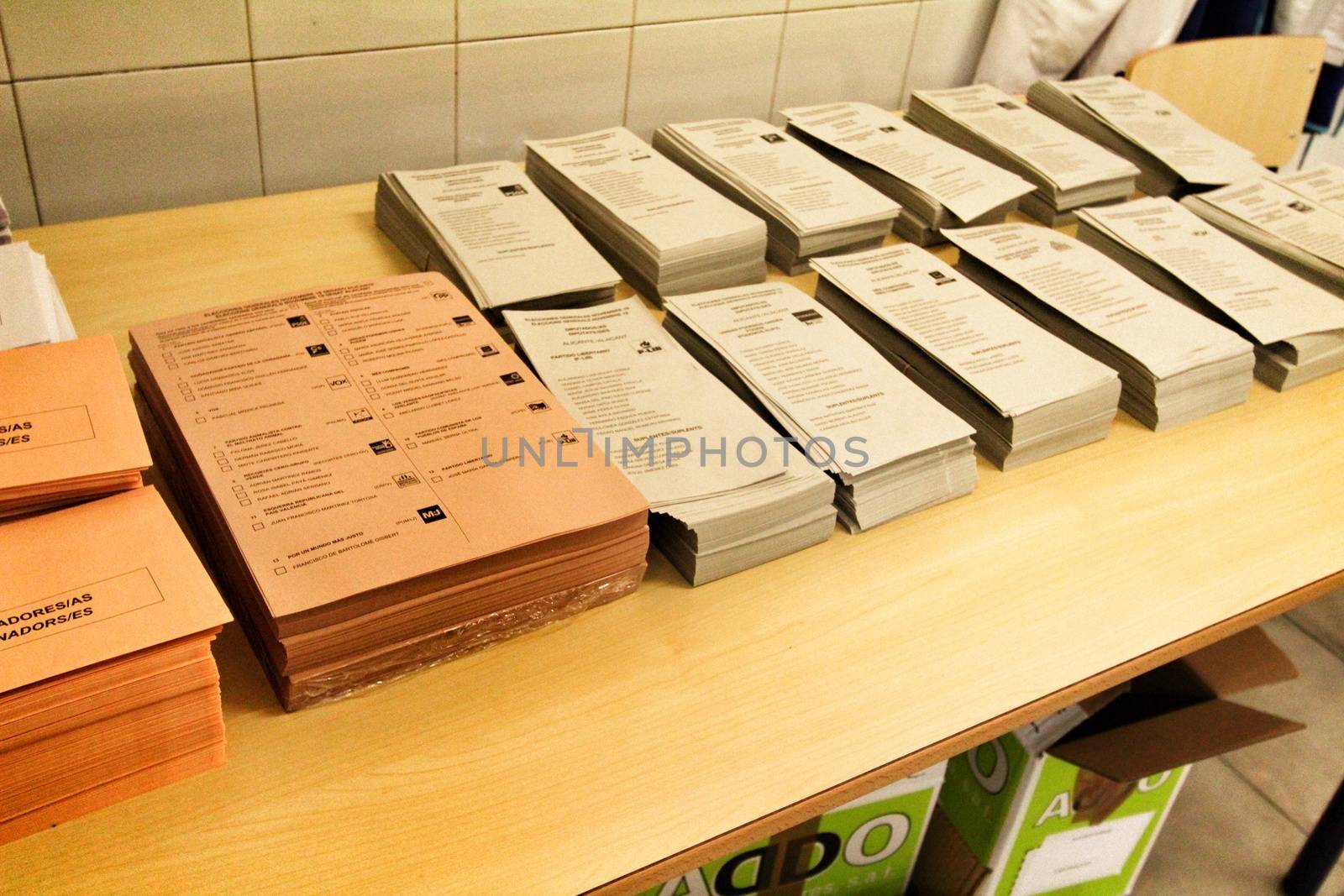 Ballots and envelops to vote on a wooden table at a polling station in Spain