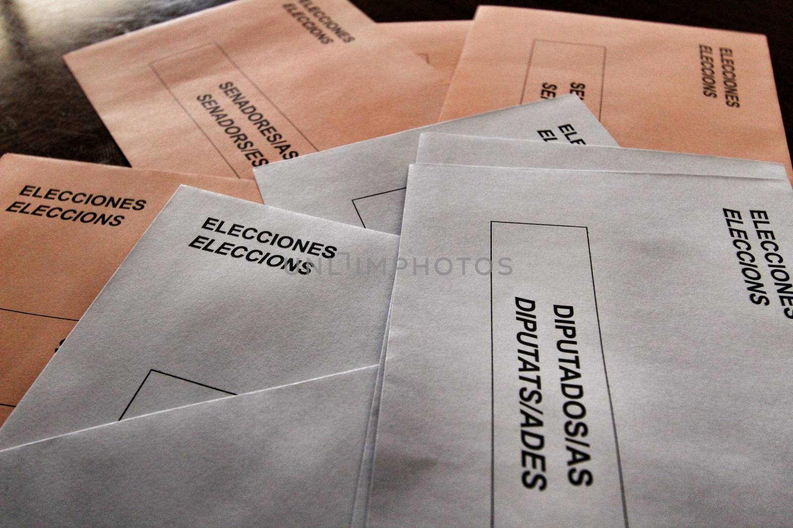 Ballots and envelops to vote on a wooden table at a polling station in Spain