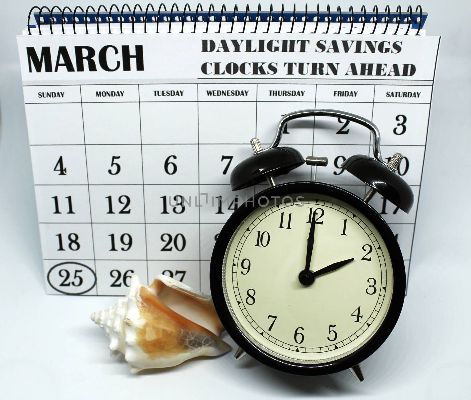 Daylight Savings Spring Forward sunday at 2:00 a.m. March 25 date indicated in the calendar. Clock next to a conch.