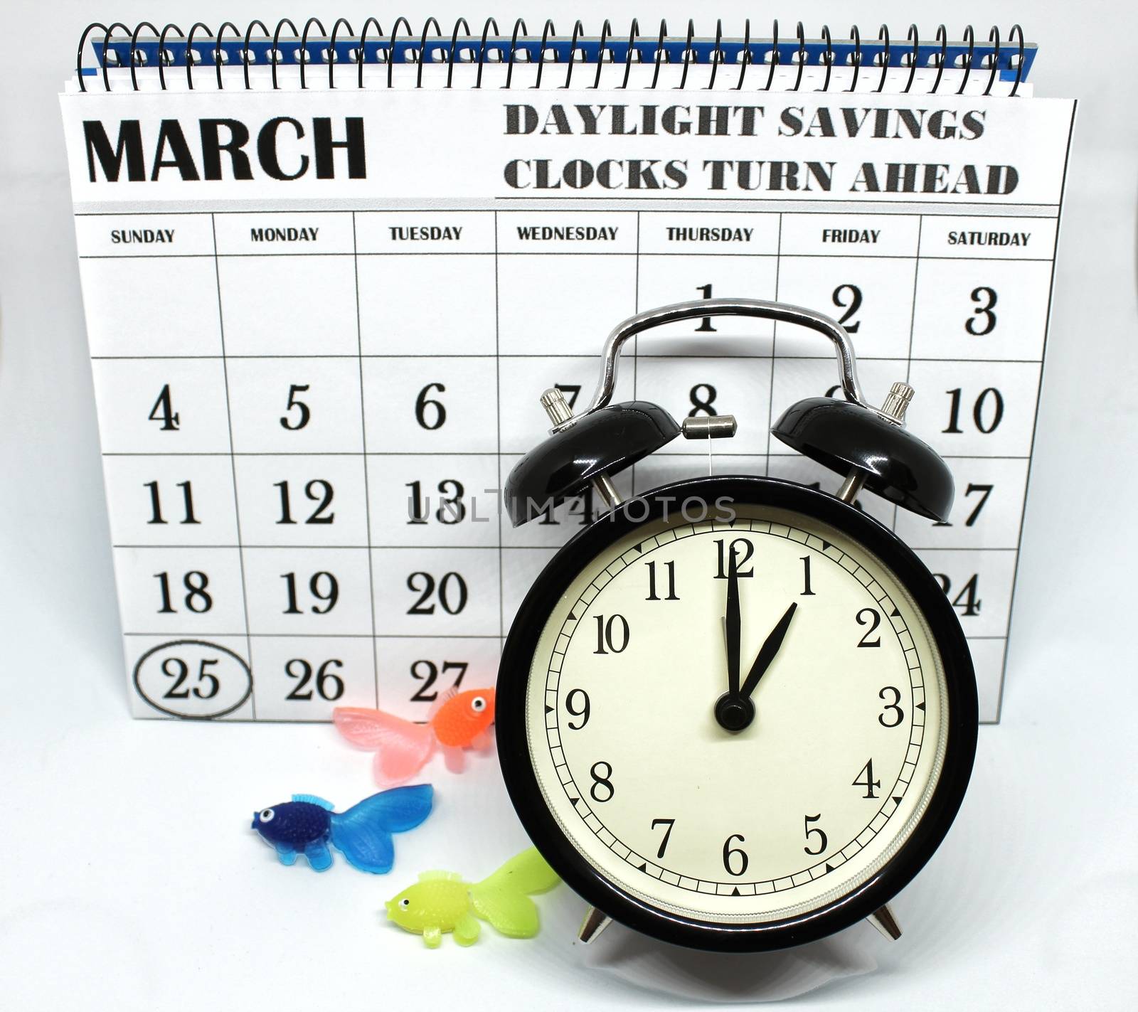 Daylight Savings Spring Forward sunday at 1:00 a.m. March 25 date indicated in the calendar. Clock next to colorful fish.