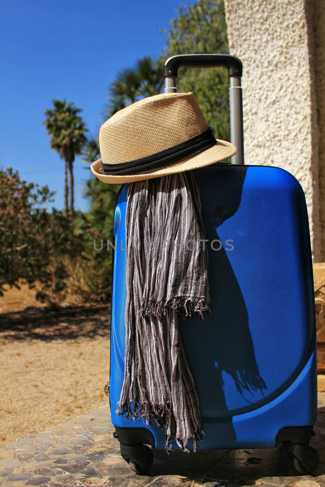 Suitcase prepared for the holidays with striped foulard and white hat by soniabonet