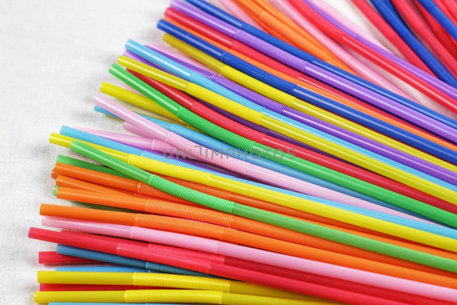 Colorful plastic drinking straws close up by soniabonet