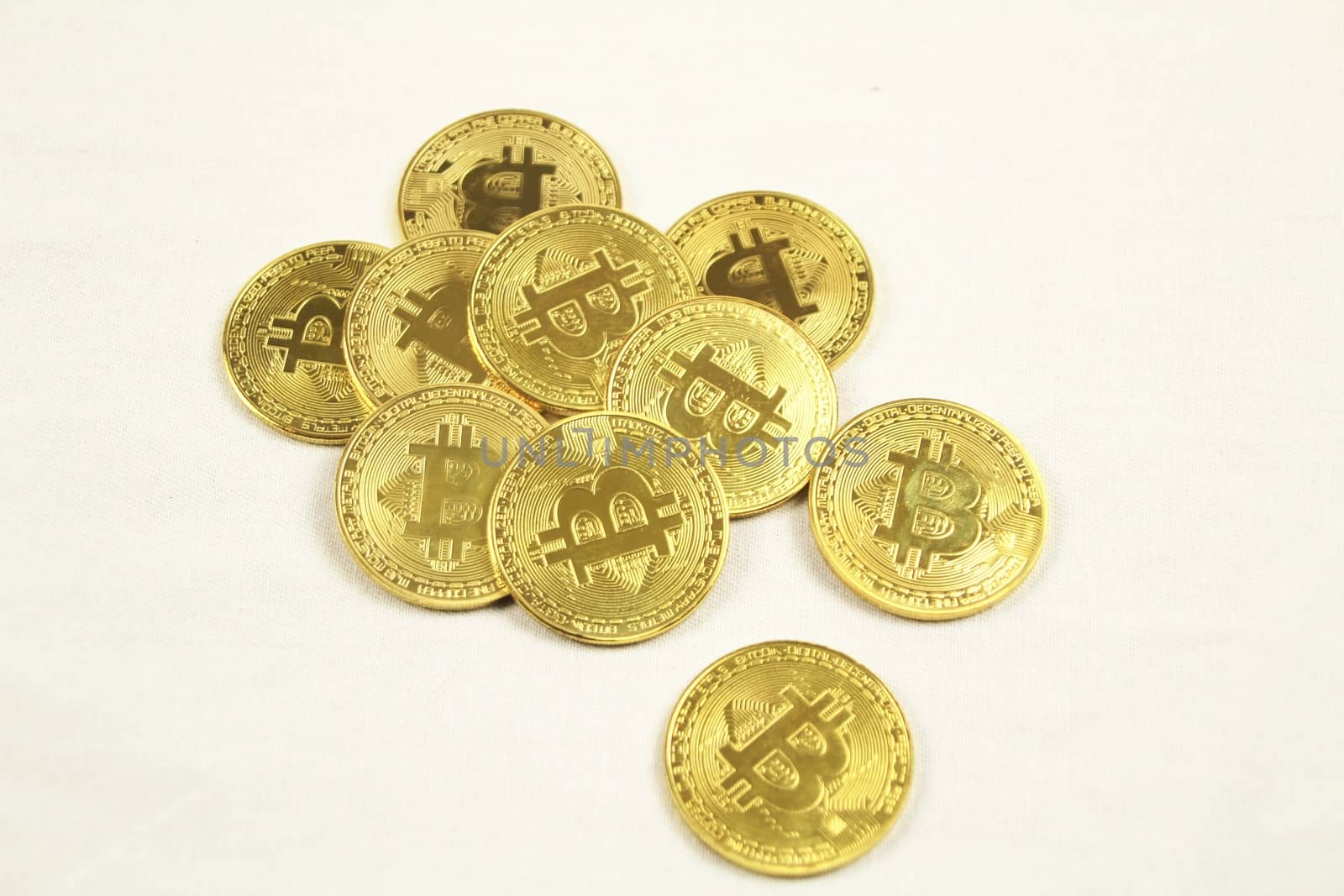 Golden bitcoins on white background by soniabonet