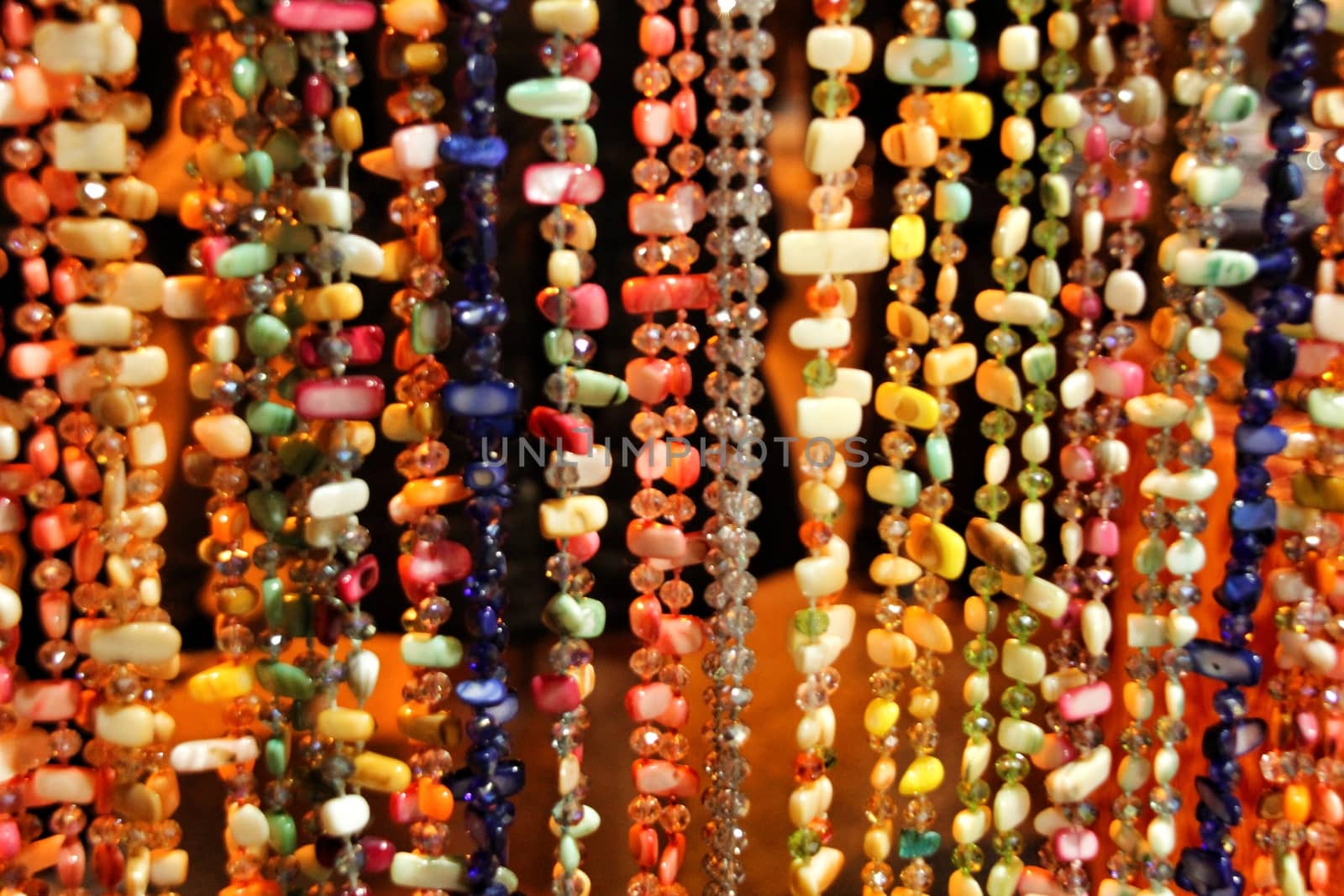 Beautiful and colorful rhinestones necklaces hanging in a street stall