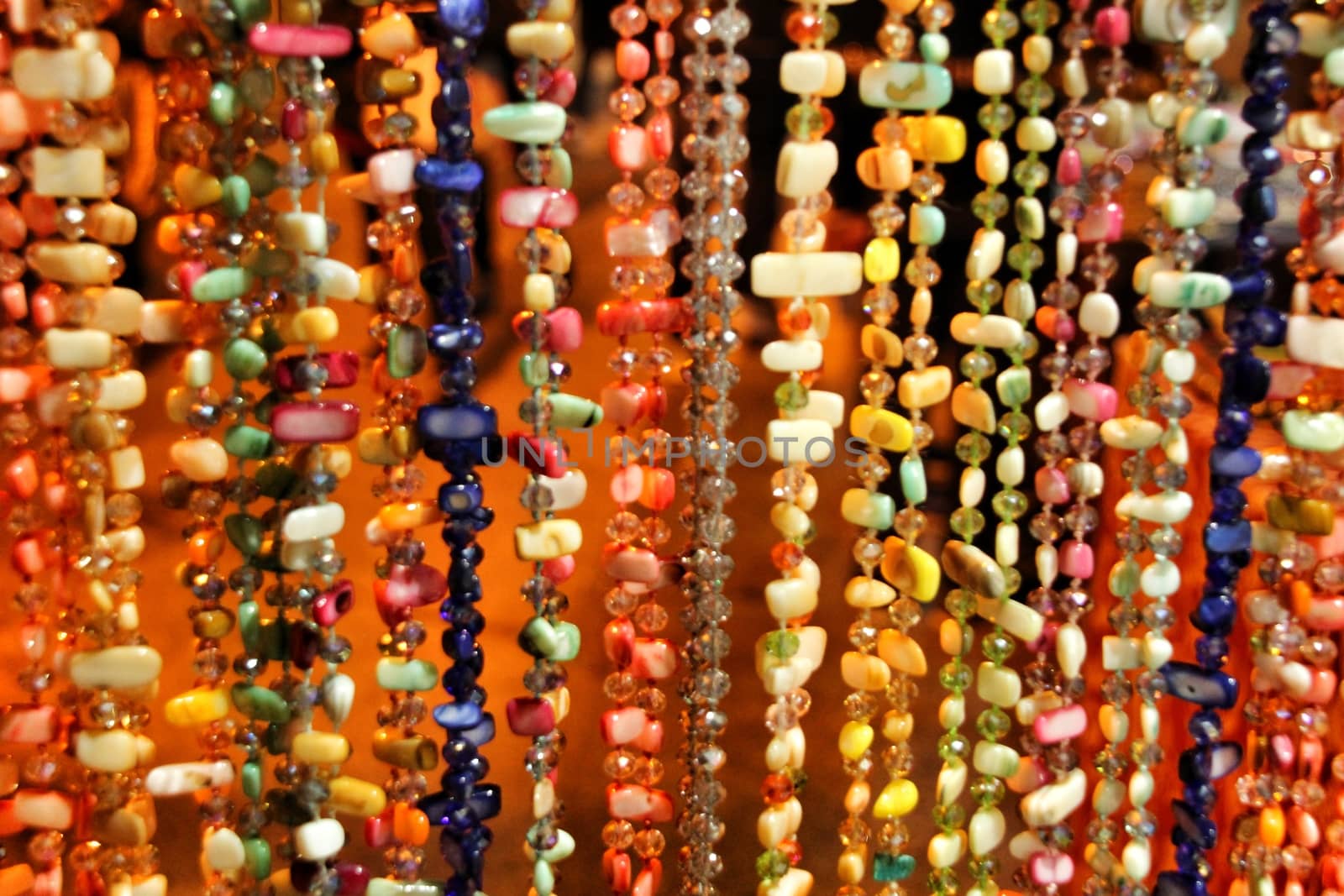 Beautiful and colorful rhinestones necklaces hanging in a street stall