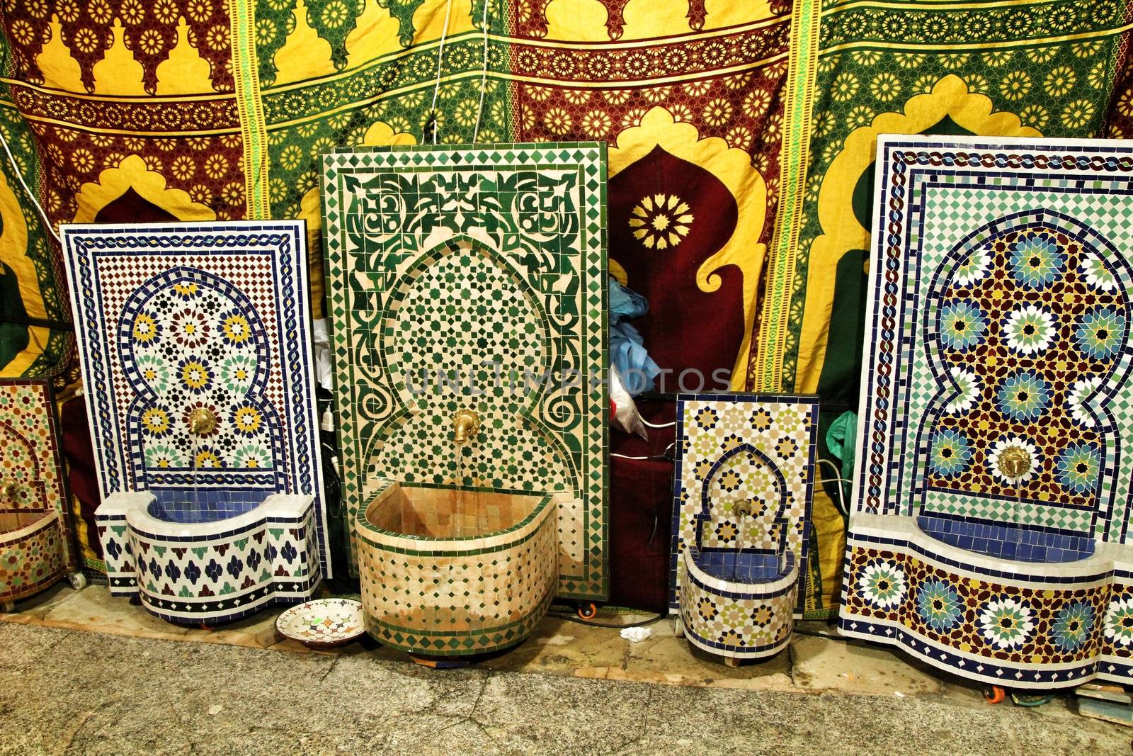 Ceramic fountains for sale at a market stall by soniabonet