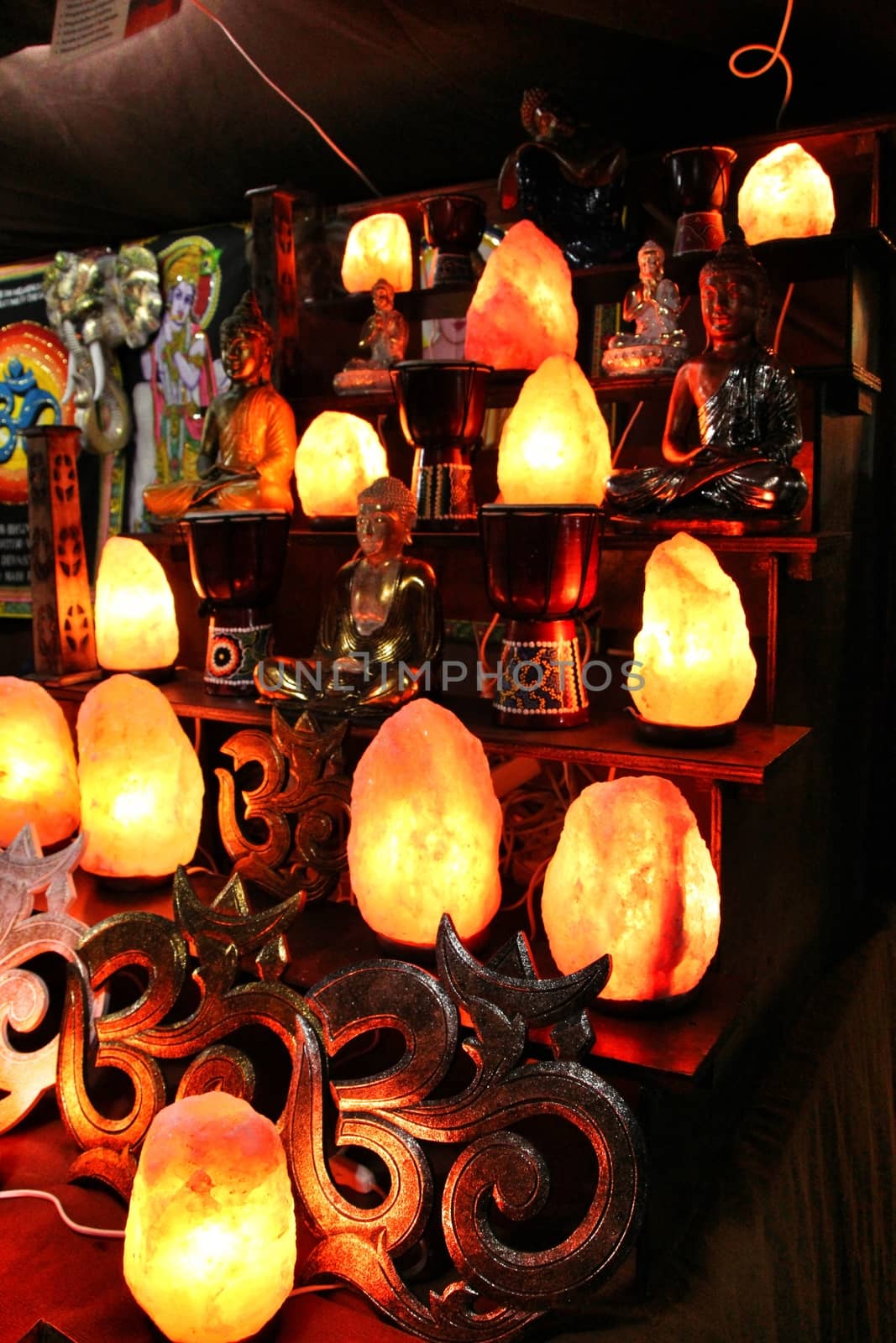 Colored glass lamps for sale at a market stall by soniabonet