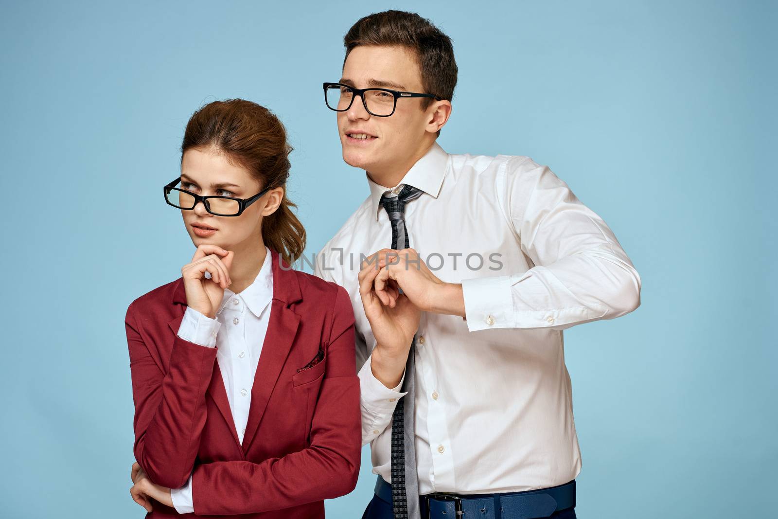 business man and woman office officials communication work colleagues studio blue background. High quality photo