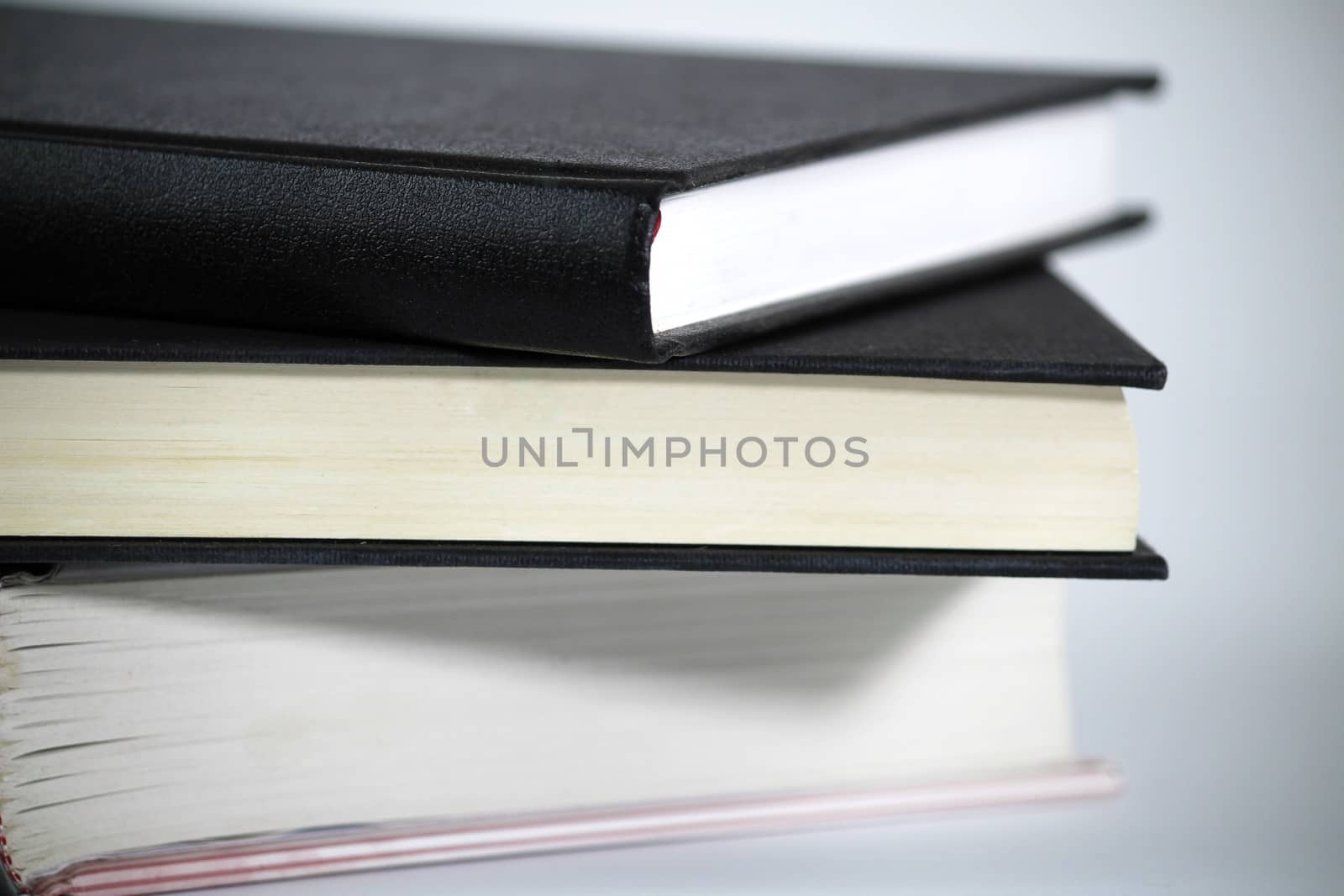 Three stacked books on white background by soniabonet