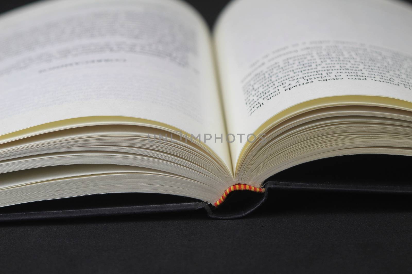 Opened book on black background by soniabonet