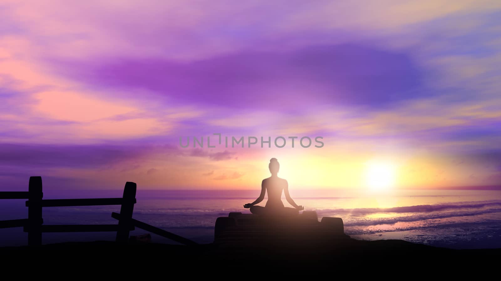 Female silhouette while meditating on the background of the ocean.