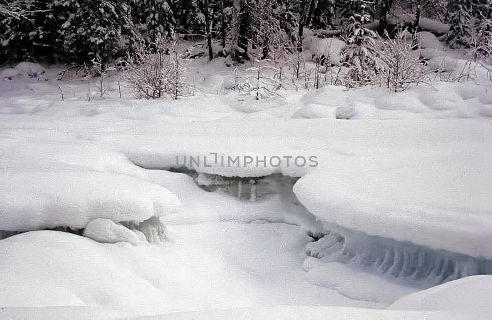 Ice and snow on the river. Melting snow in the spring on the reservoir.