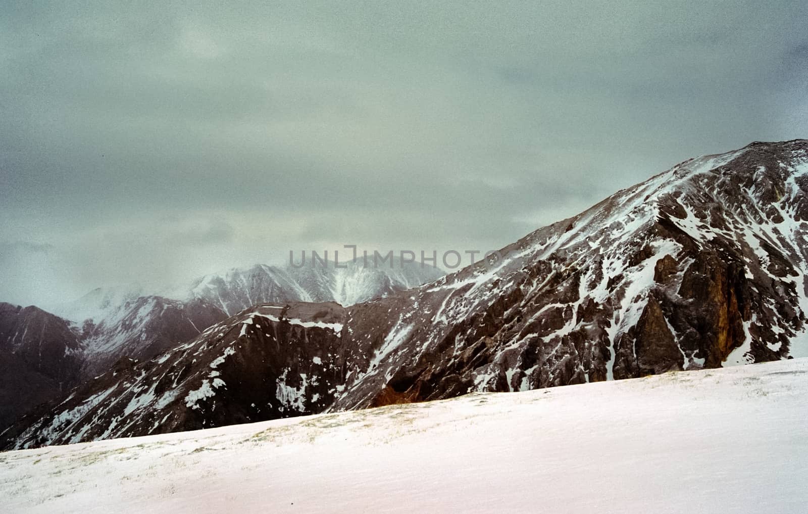 Mount Sayan in winter in the snow. The nature of the mountains is sayan.