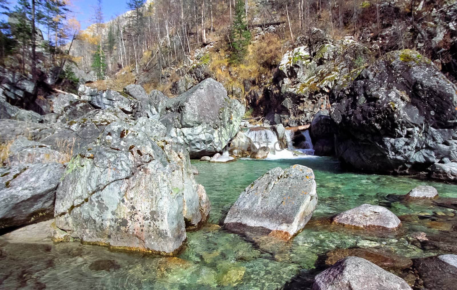 Mountain river. Stones and water of a mountain river. The mountains are said.