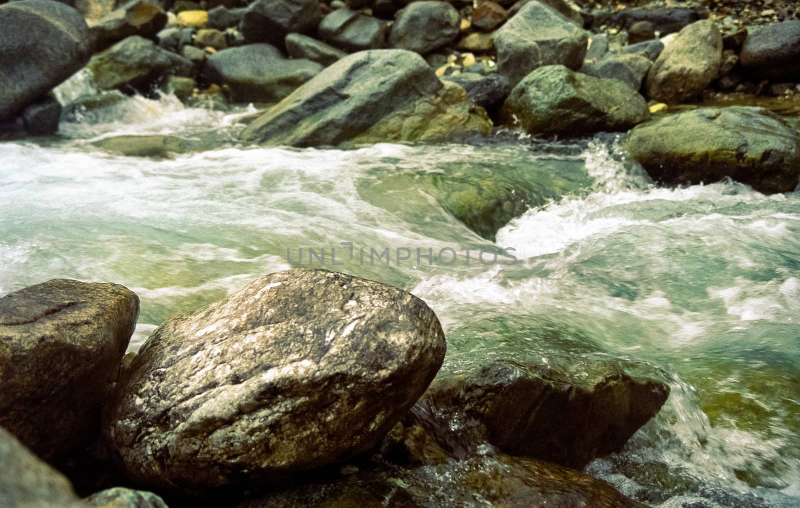 Mountain river. Stones and water of a mountain river. The mountains are said.