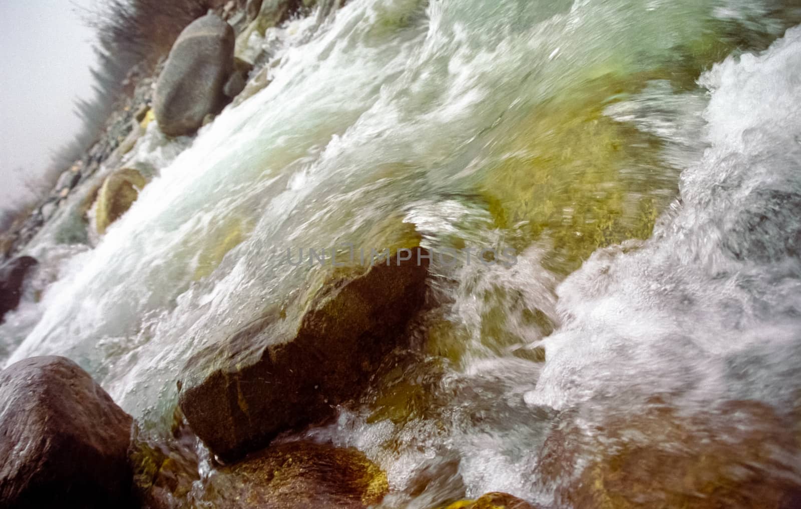 Mountain river. Stones and water of a mountain river. The mountains are said.