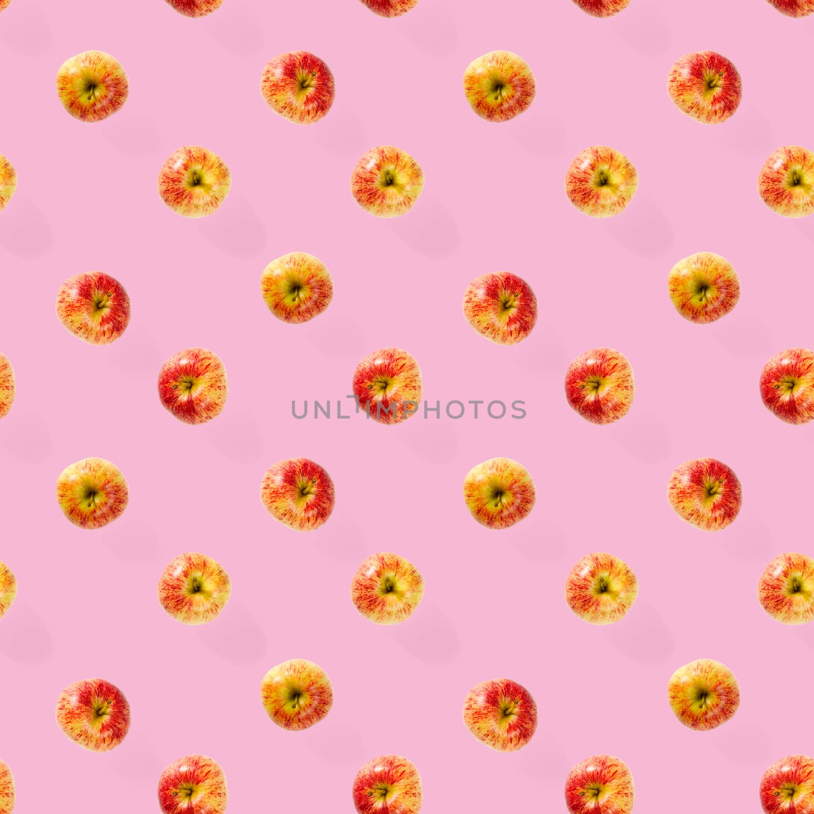 Seamless pattern with ripe apples. Apple seamless pattern on pink background. Tropical fruit abstract background.