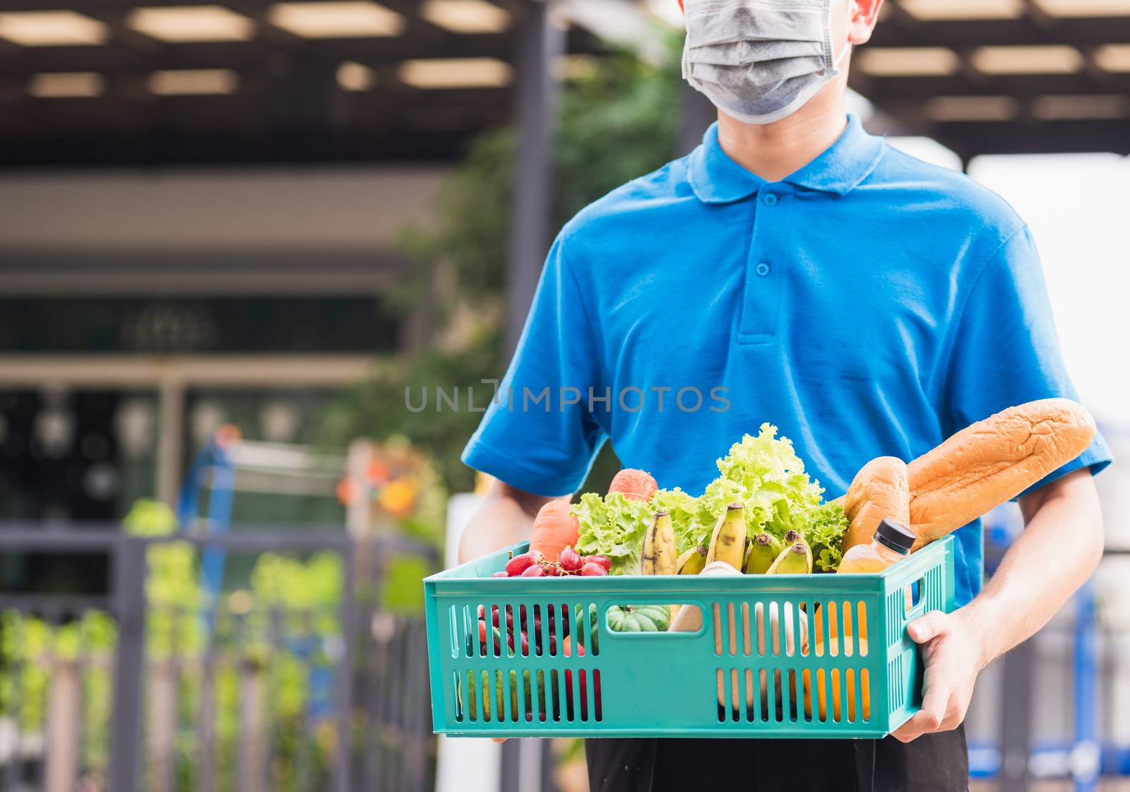 Delivery man wearing face mask protect he delivering fresh food  by Sorapop