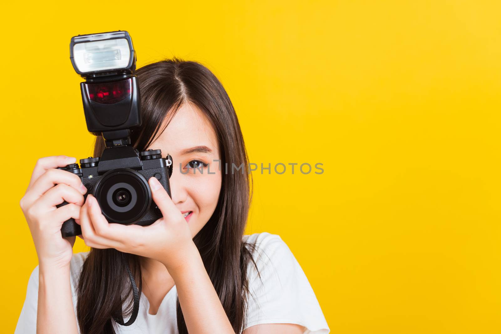 Woman photographer taking picture and looking viewfinder on digi by Sorapop