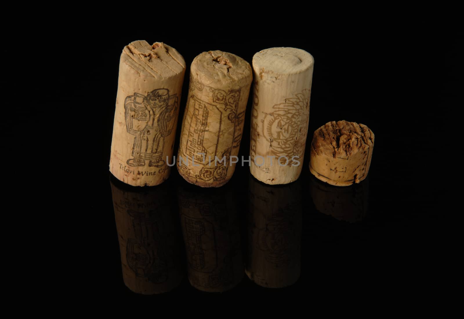 Tashkent, Uzbekistan - October 6, 2009 : Heap of old wine corks on black background with reflection. Studio photography