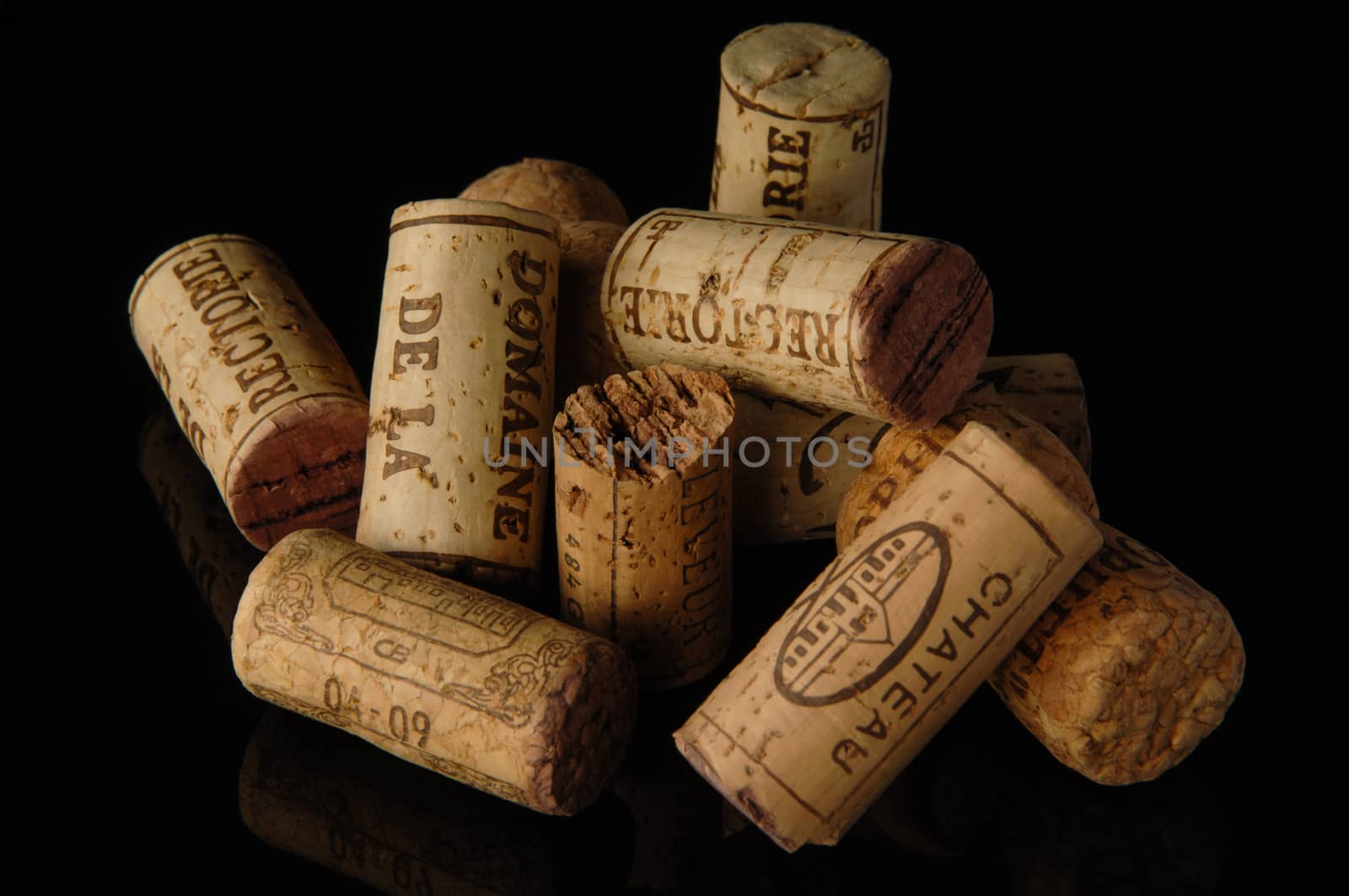 Tashkent, Uzbekistan - October 6, 2009 : Heap of old wine corks on black background with reflection. Studio photography