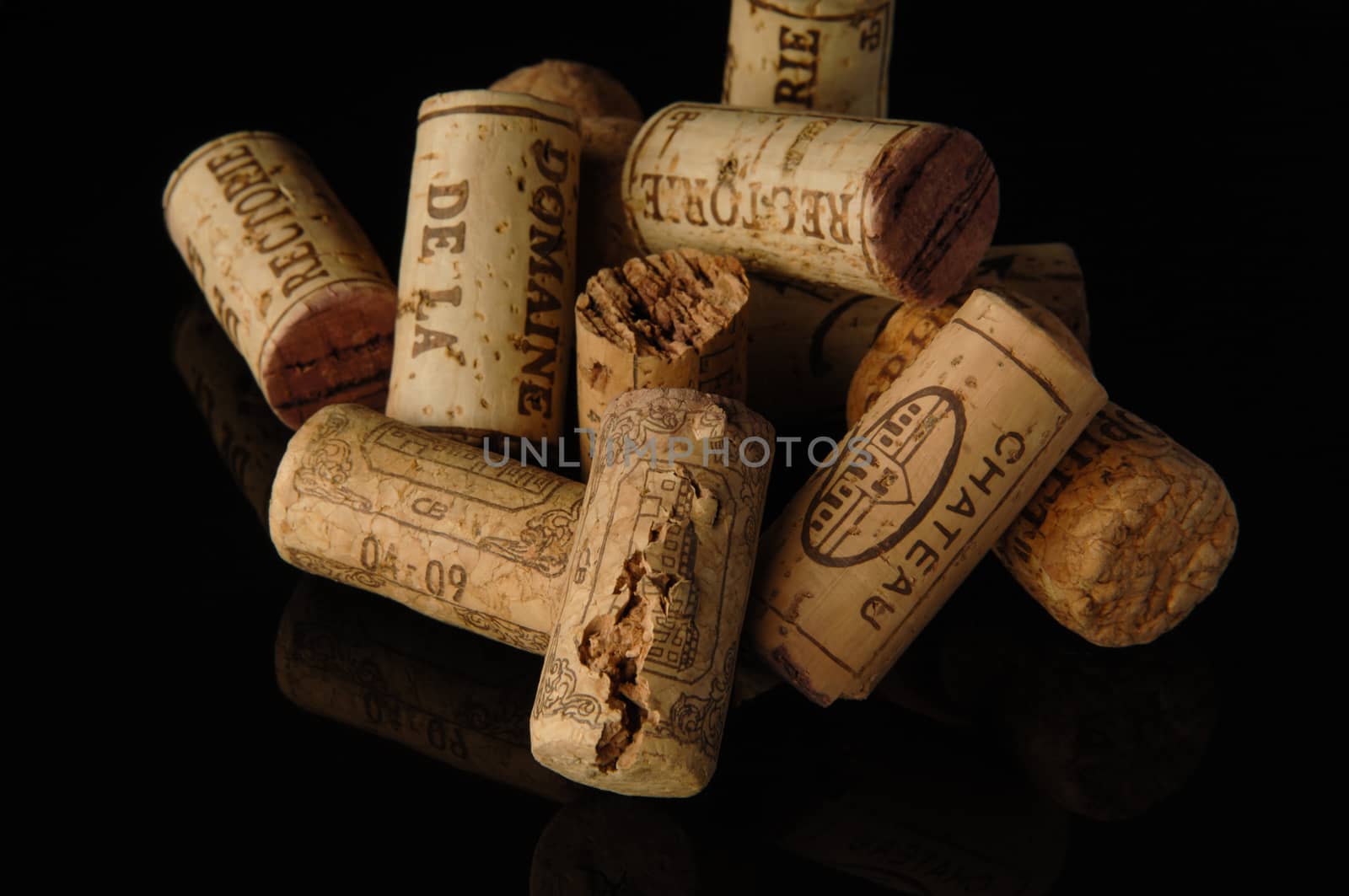 Tashkent, Uzbekistan - October 6, 2009 : Heap of old wine corks on black background with reflection. Studio photography