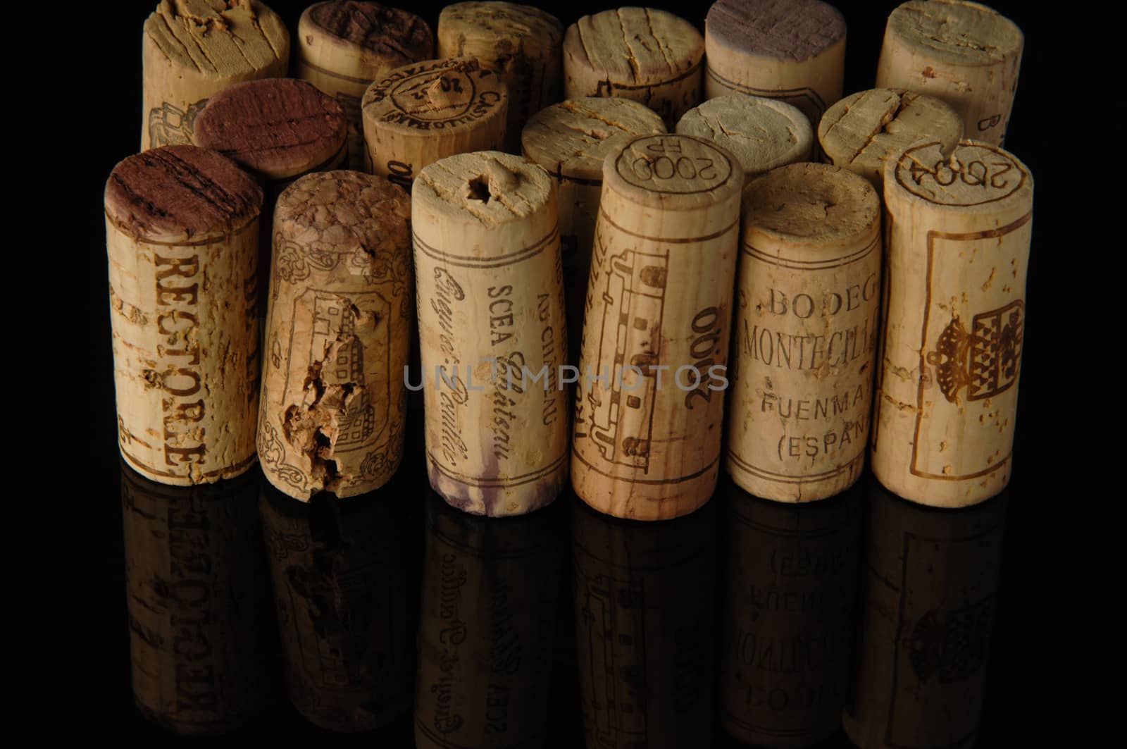 Tashkent, Uzbekistan - October 6, 2009 : Heap of old wine corks on black background with reflection. Studio photography