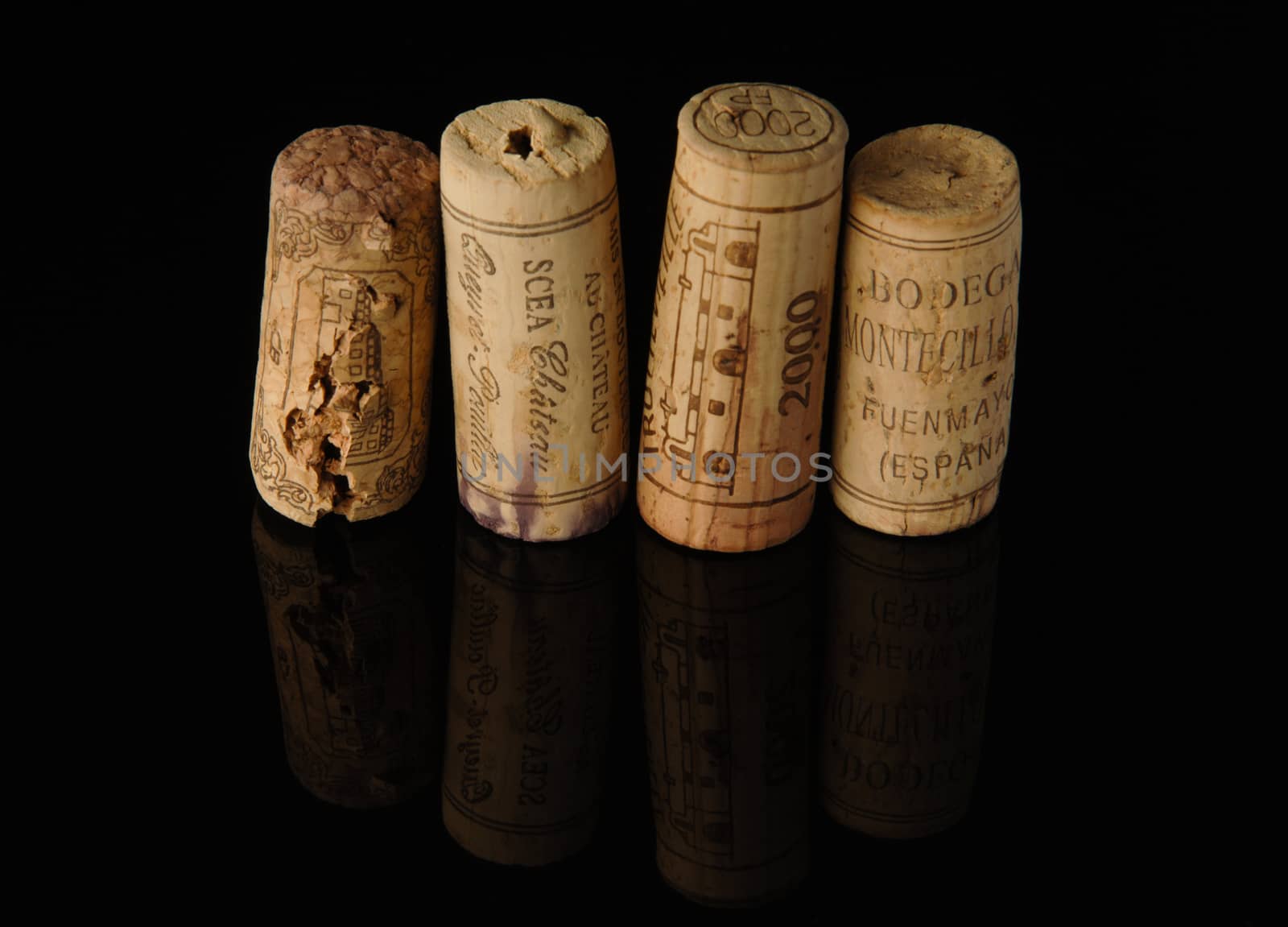 Tashkent, Uzbekistan - October 6, 2009 : Heap of old wine corks on black background with reflection. Studio photography