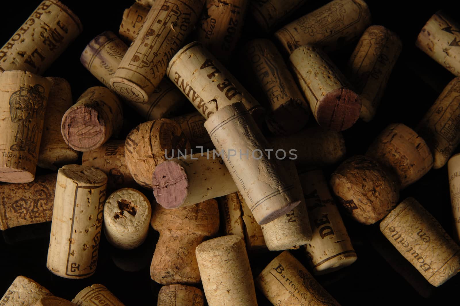 Tashkent, Uzbekistan - October 6, 2009 : Heap of old wine corks on black background. Studio photography